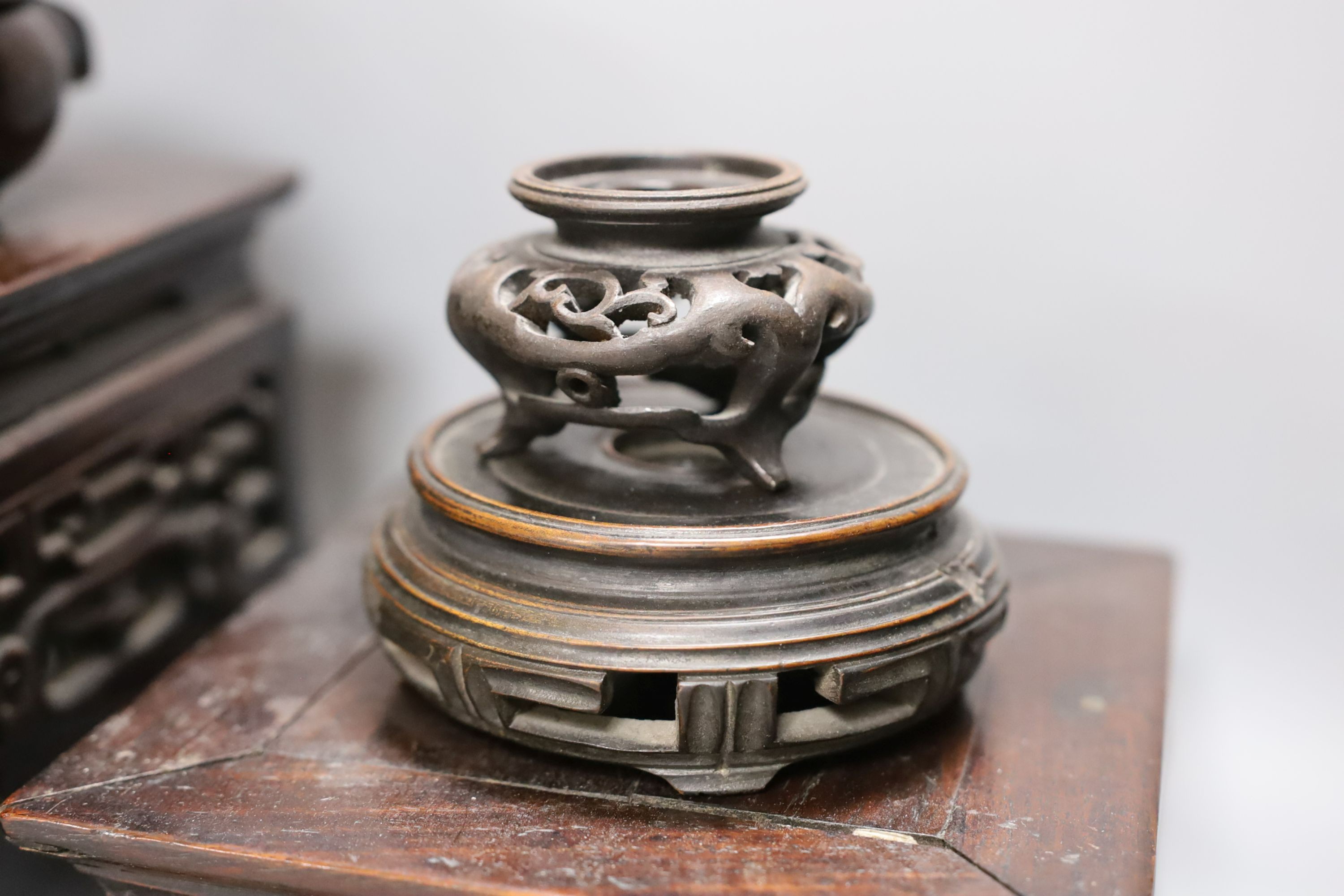 A Chinese carved hardwood 3 tier stand, late Qing, together with other similar stands. Largest 49cm